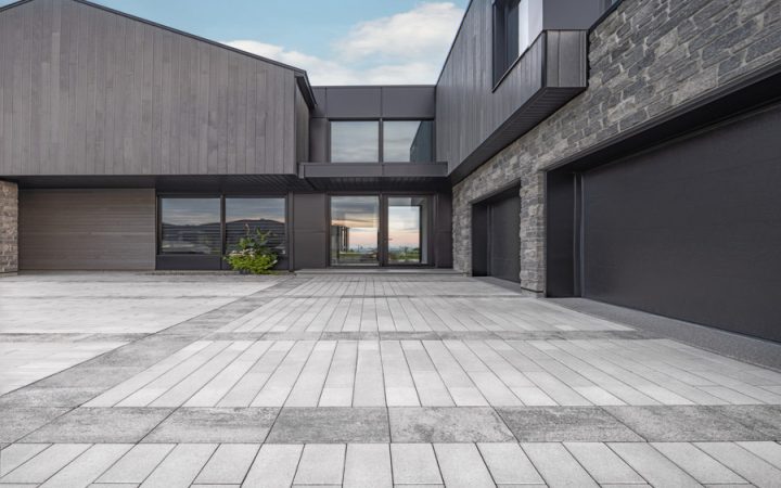 A sleek and modern concrete driveway with precise lines, enhancing the architectural beauty of a contemporary home.