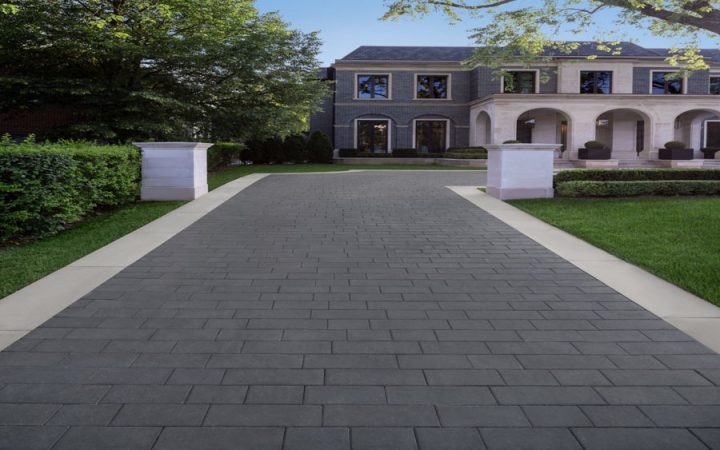 A contemporary driveway design using precast concrete pavers, offering durability and aesthetic appeal for residential properties.