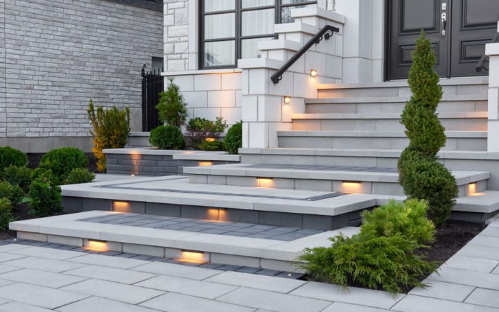 Stylish concrete steps with built-in lighting, creating a welcoming and elegant entrance to a modern home.