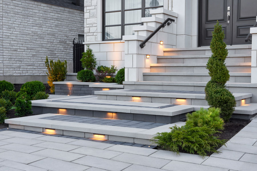 Stylish concrete steps with built-in lighting, creating a welcoming and elegant entrance to a modern home.